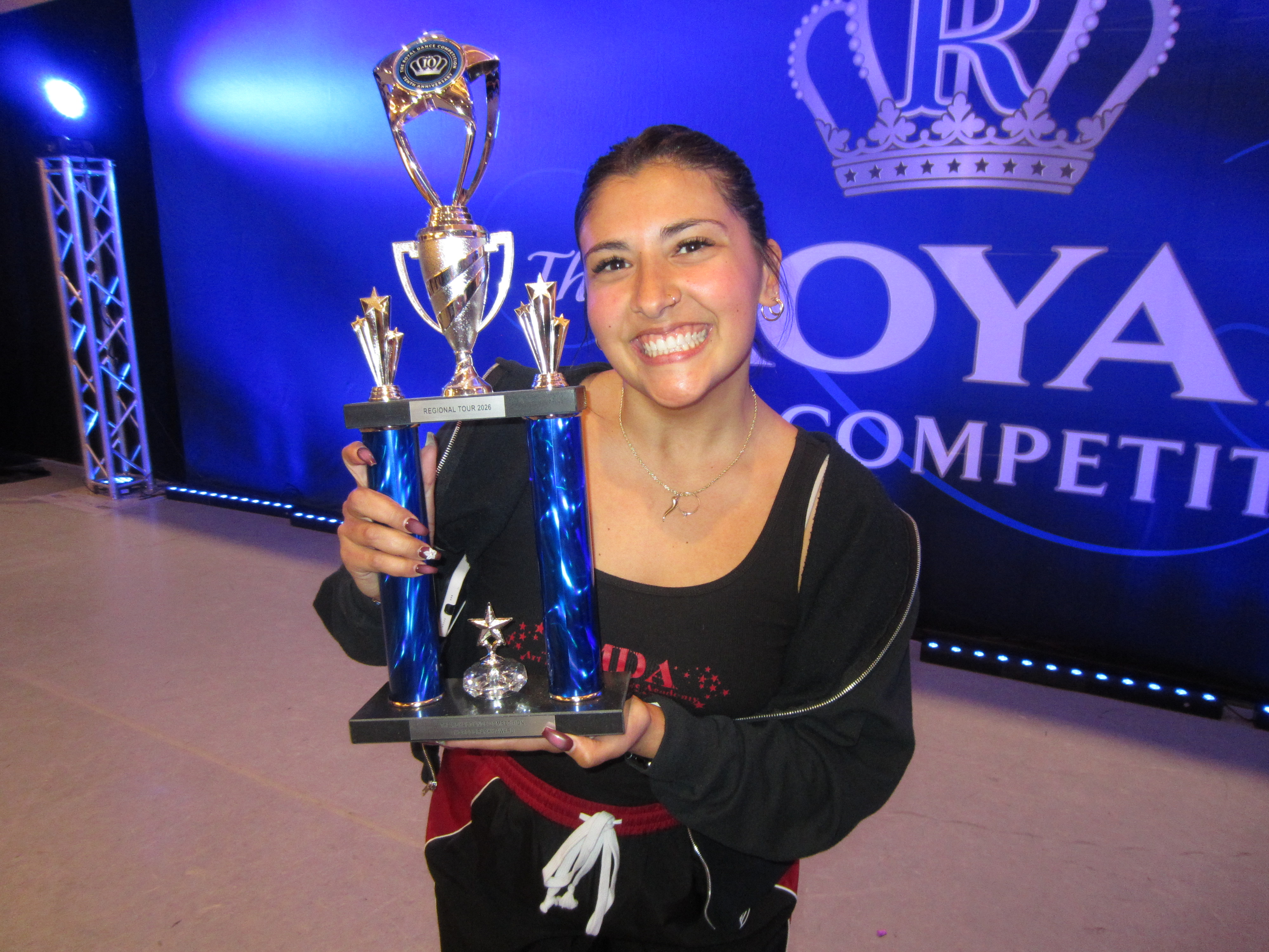 Michaela Curcio holding a choreography trophy at The Royal Competition