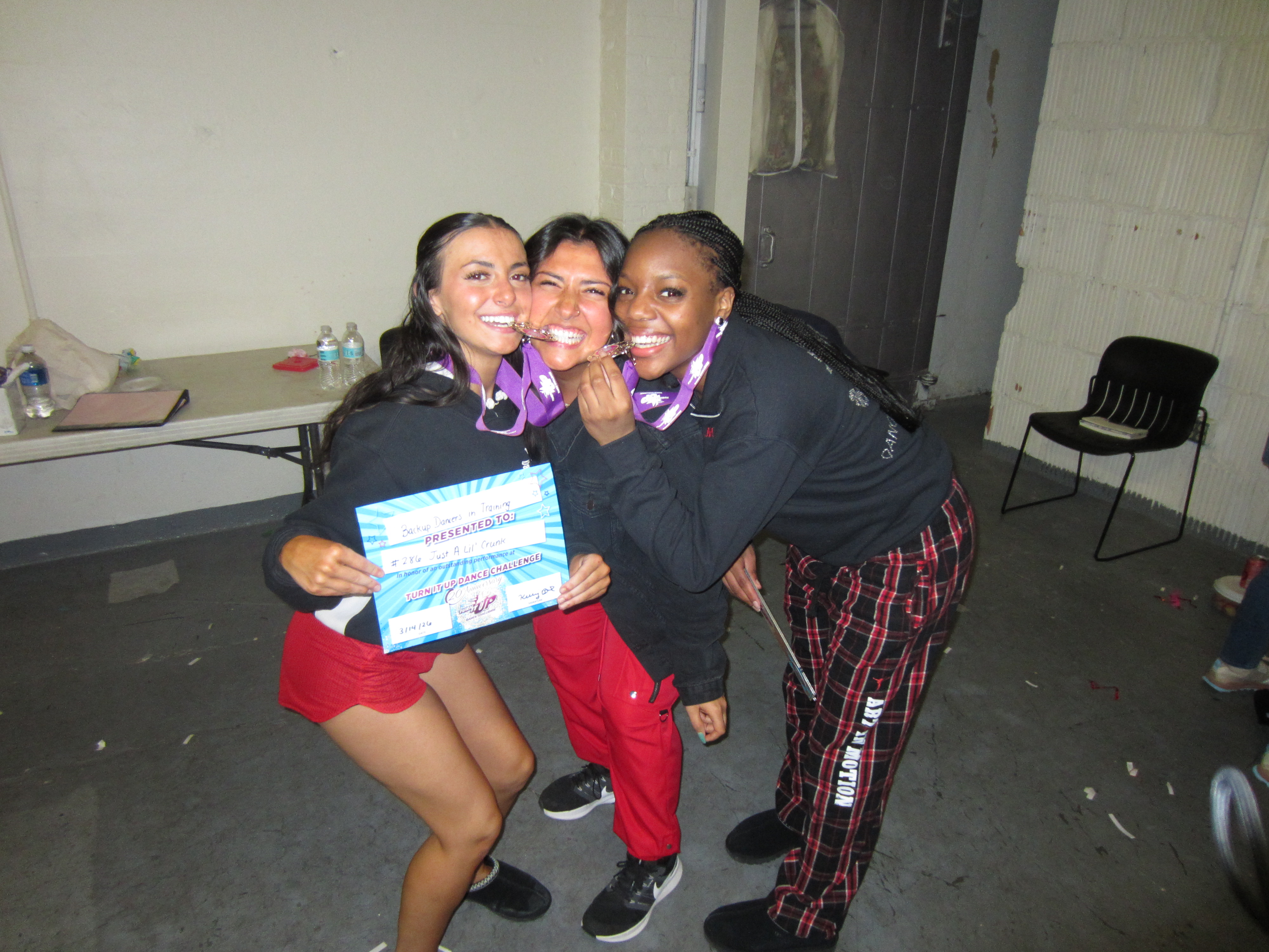 Dancers with medals after a first-place competition set