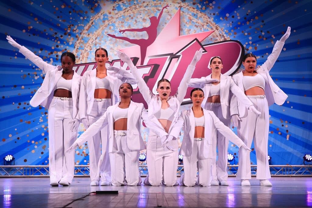 Move Fit Choreo dancers on stage in white outfits